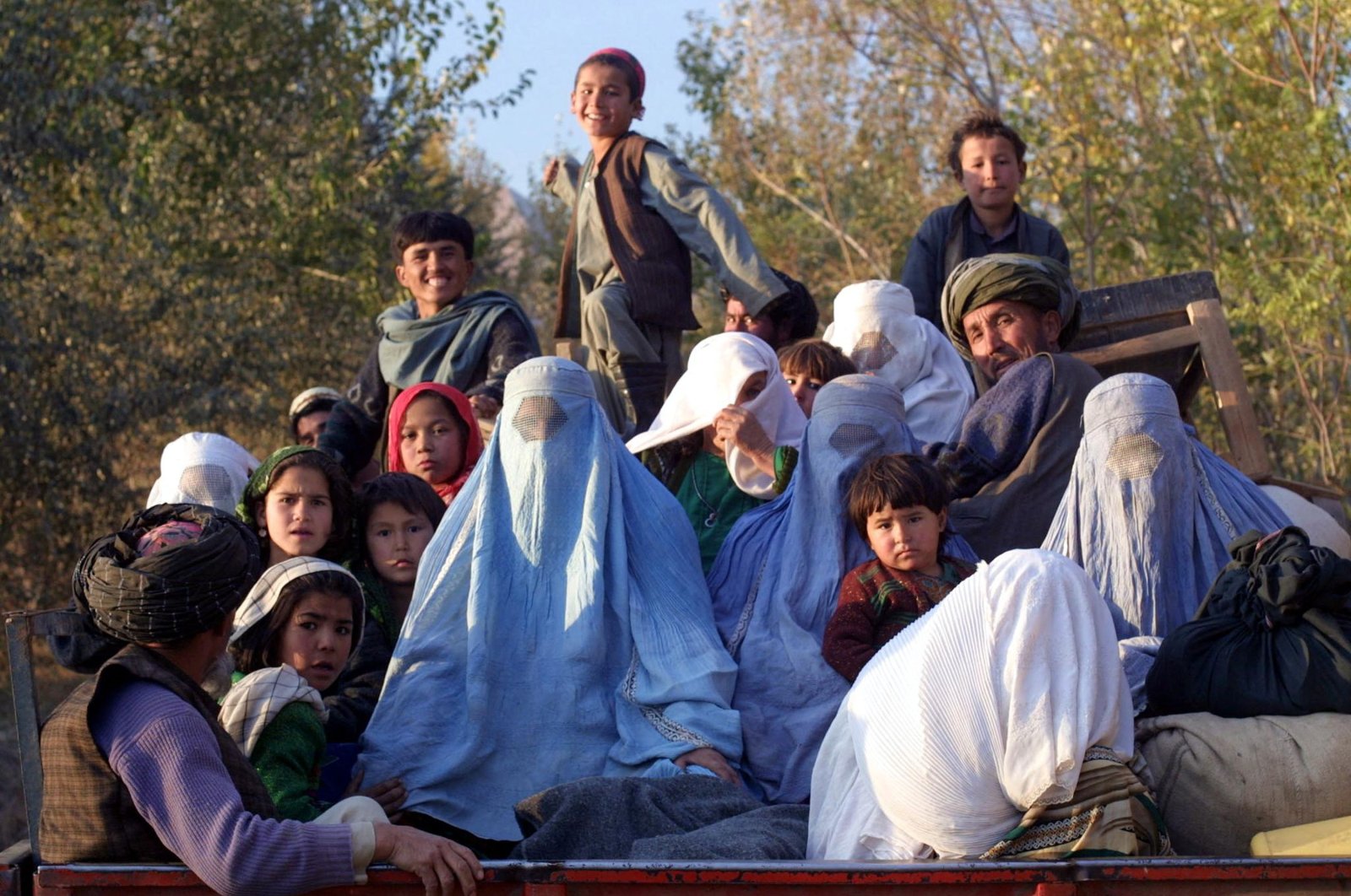 Residents of the northeastern Afghan village of Kalaqata in Takhar province fleeing the frontline area as U.S. fighter planes bomb Taliban positions nearby, Nov. 4, 2001.